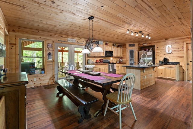 dining area featuring wooden walls, wooden ceiling, french doors, rail lighting, and dark wood finished floors
