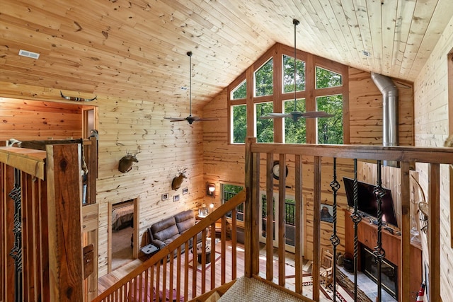 additional living space with wooden walls, wooden ceiling, ceiling fan, and vaulted ceiling