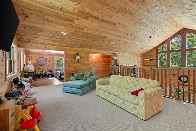 carpeted living area featuring wood walls, wood ceiling, ceiling fan, and high vaulted ceiling