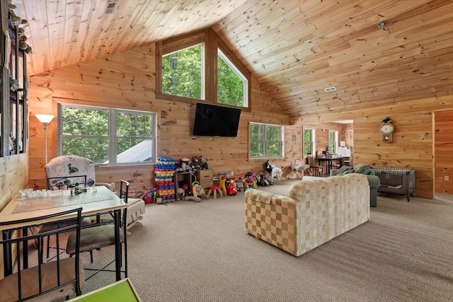 carpeted living area featuring wooden walls, high vaulted ceiling, and wooden ceiling