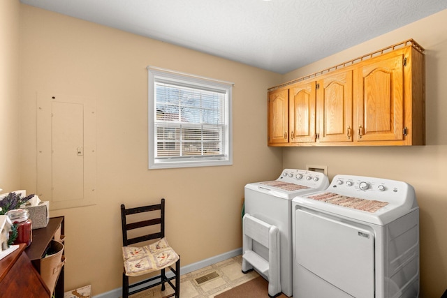 laundry room with cabinets and washer and dryer