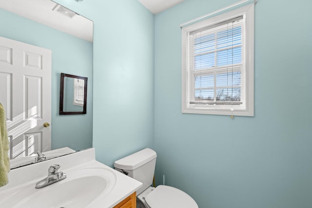 bathroom featuring toilet and vanity