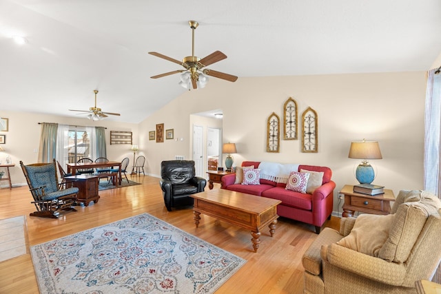 living room featuring ceiling fan, vaulted ceiling, and light hardwood / wood-style floors