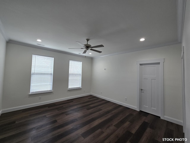 spare room featuring dark wood-type flooring, ornamental molding, and ceiling fan