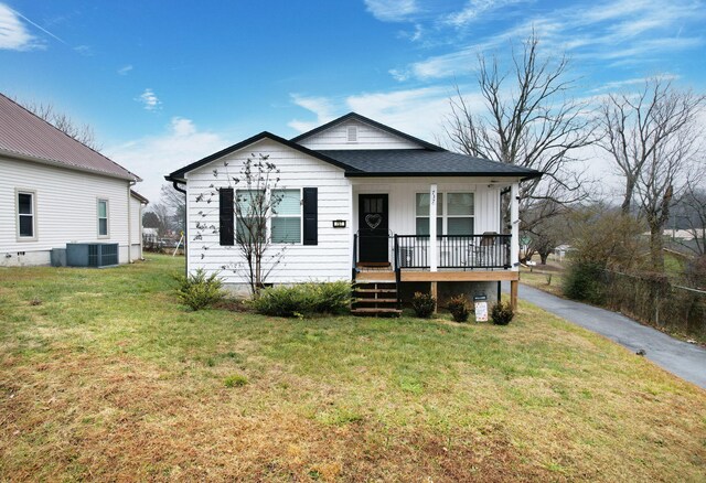 back of house with a yard and a porch