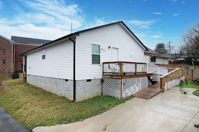 view of property exterior featuring a wooden deck and a yard