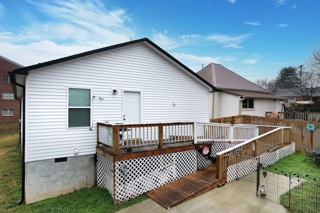 back of house with a deck