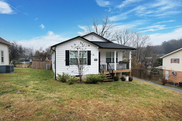 view of front of property with a porch, central AC, and a front yard