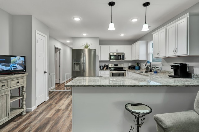 kitchen featuring white cabinetry, appliances with stainless steel finishes, light stone countertops, and sink