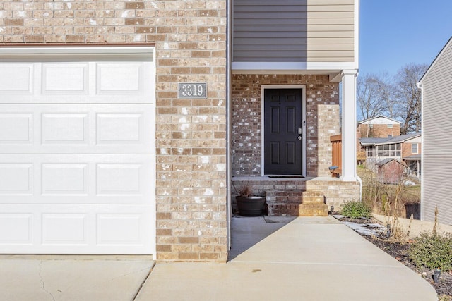 view of exterior entry with a garage