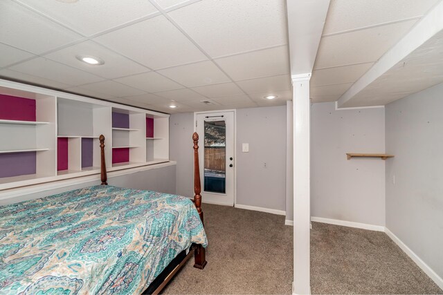 carpeted bedroom with a drop ceiling