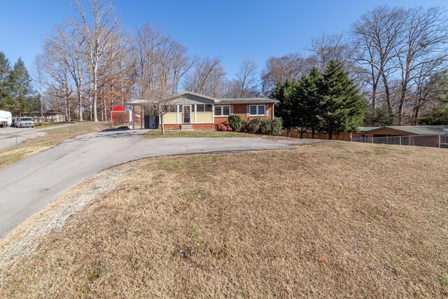 single story home with a carport and a front yard