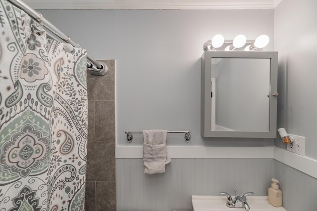 bathroom with sink and curtained shower