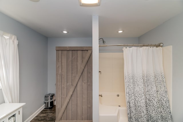 bathroom featuring hardwood / wood-style floors and shower / bath combination with curtain