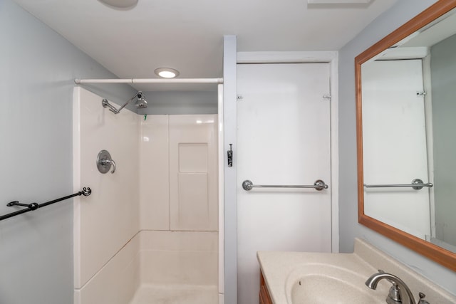 bathroom with vanity and a shower