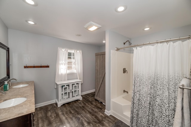 bathroom featuring vanity, wood-type flooring, and shower / bath combo