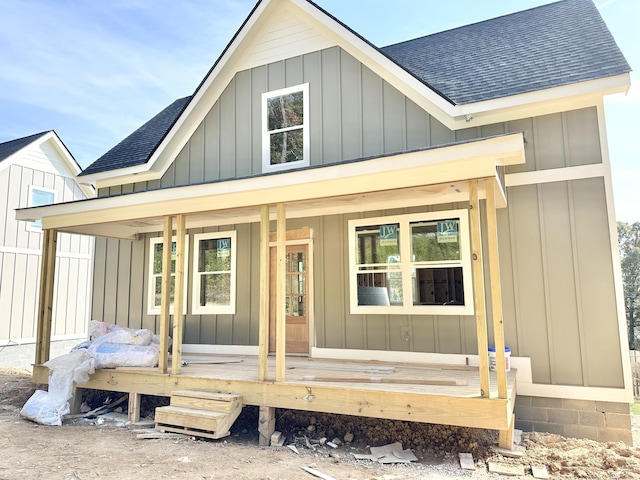 rear view of house featuring covered porch