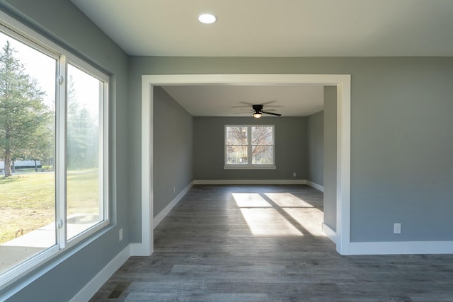 spare room featuring ceiling fan and dark wood-type flooring