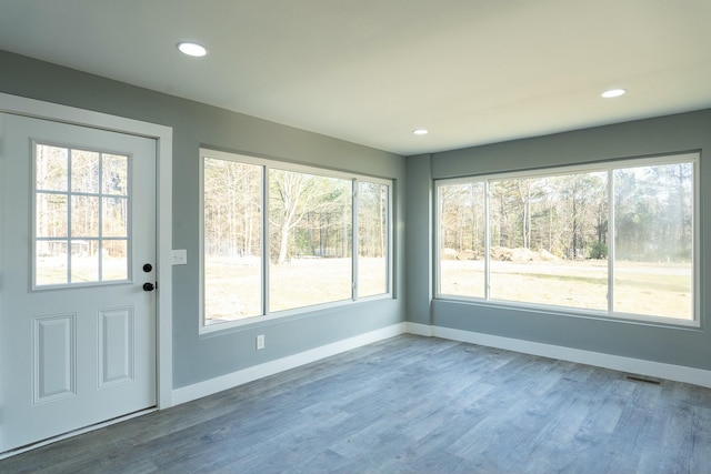 unfurnished sunroom with a wealth of natural light