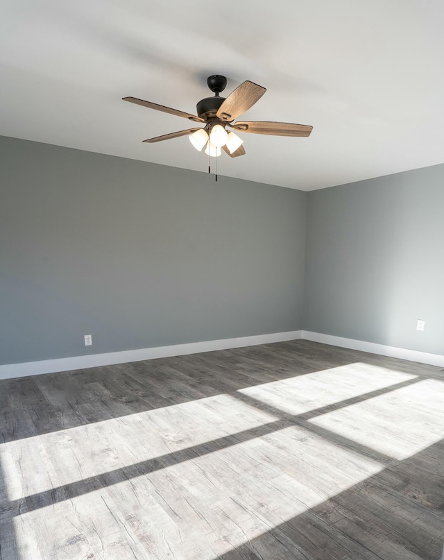 spare room featuring wood-type flooring and ceiling fan