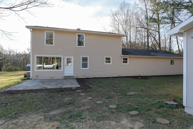 rear view of property featuring a lawn and a patio