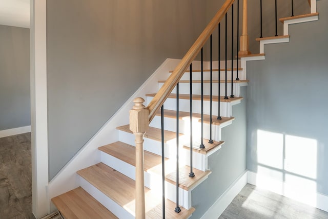 stairs featuring hardwood / wood-style flooring