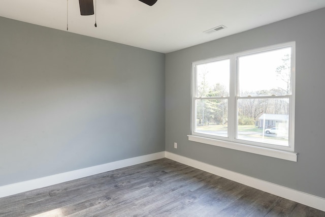 spare room featuring ceiling fan and dark hardwood / wood-style flooring