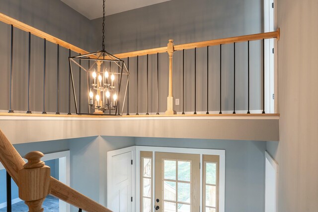 hallway featuring dark hardwood / wood-style flooring and an inviting chandelier