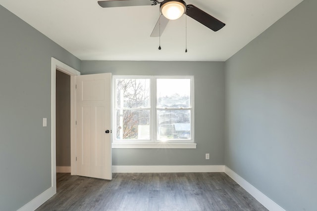 empty room with ceiling fan and dark wood-type flooring