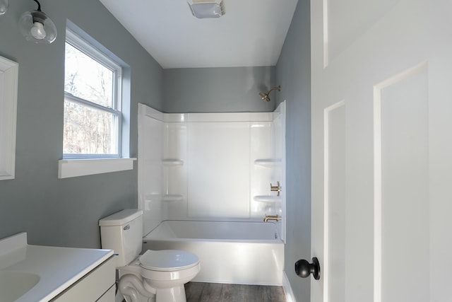 full bathroom featuring toilet, hardwood / wood-style floors, vanity, and tub / shower combination