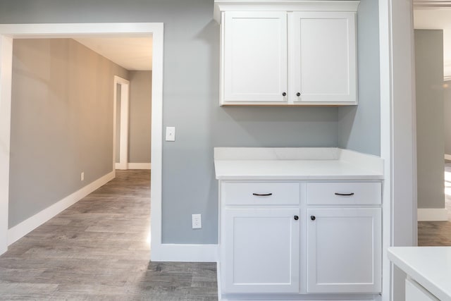 interior space with light hardwood / wood-style flooring and white cabinetry