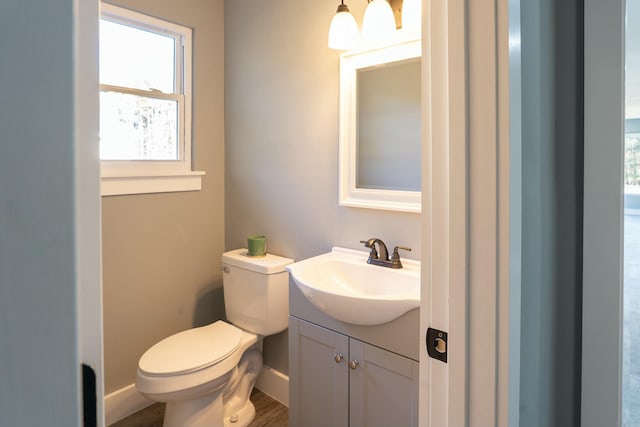 bathroom with vanity, hardwood / wood-style flooring, and toilet