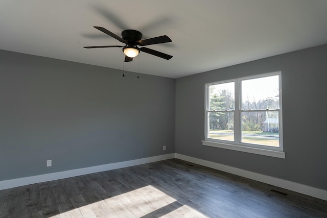 unfurnished room with ceiling fan and dark wood-type flooring