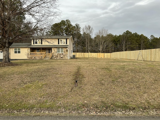 view of front of house with a front yard and covered porch