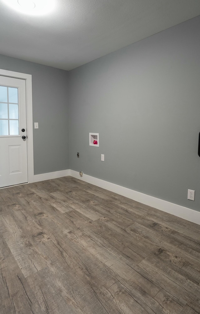 laundry area featuring hookup for an electric dryer, washer hookup, a textured ceiling, and hardwood / wood-style flooring