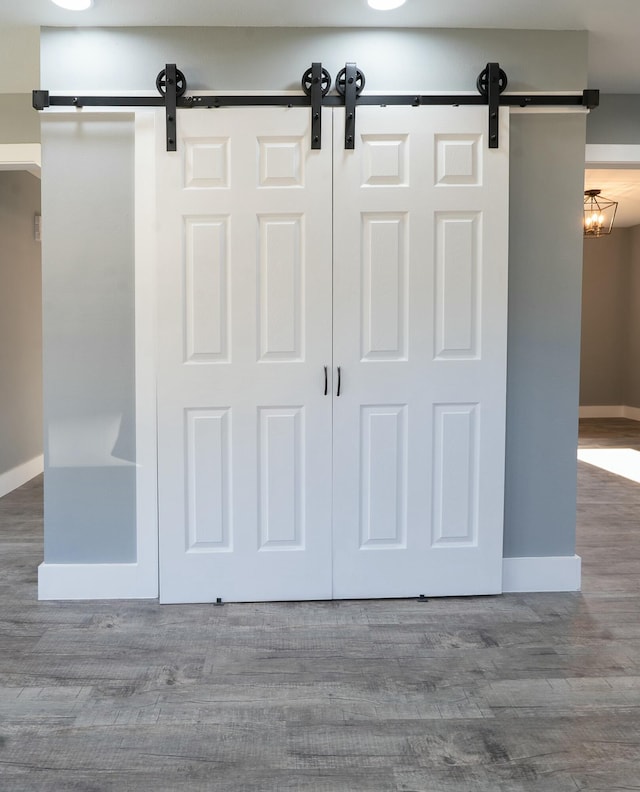 room details with a barn door and wood-type flooring