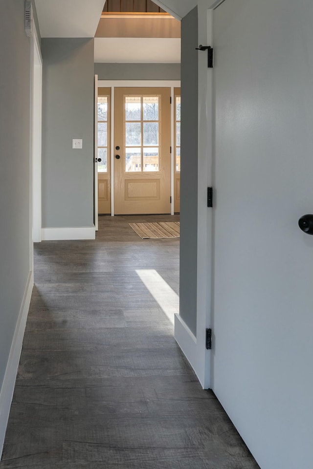 corridor with dark hardwood / wood-style flooring