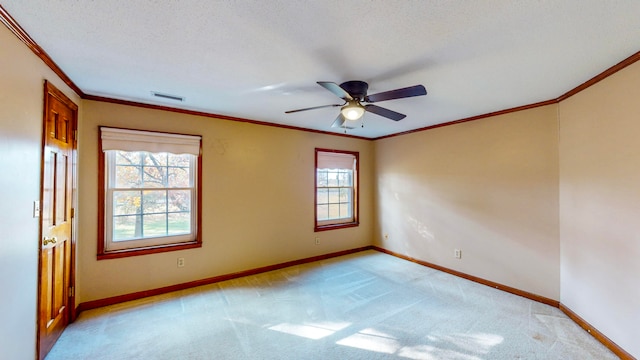 unfurnished room with light carpet, ceiling fan, a healthy amount of sunlight, and a textured ceiling