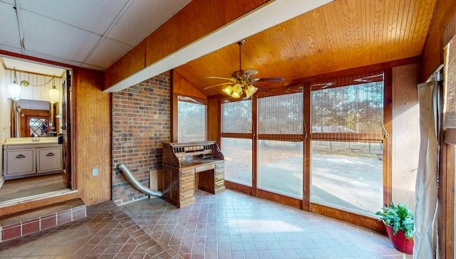 unfurnished sunroom with ceiling fan and lofted ceiling