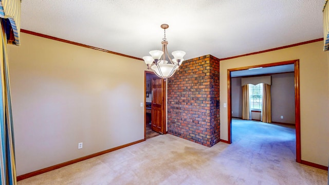 carpeted spare room with ornamental molding, a textured ceiling, and an inviting chandelier