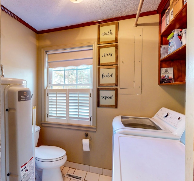 laundry room featuring tile patterned floors, a textured ceiling, crown molding, water heater, and washing machine and clothes dryer