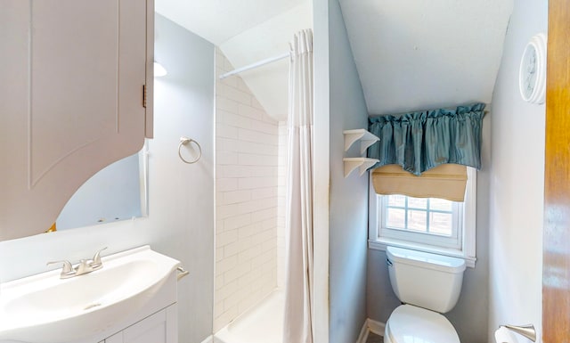 bathroom featuring curtained shower, vanity, vaulted ceiling, and toilet