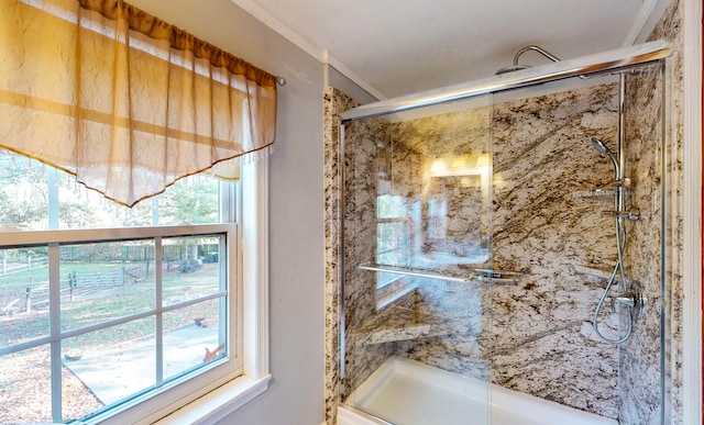 bathroom with ornamental molding and a shower with shower door