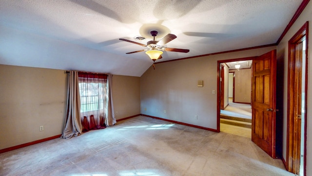 carpeted empty room with lofted ceiling, ceiling fan, and a textured ceiling