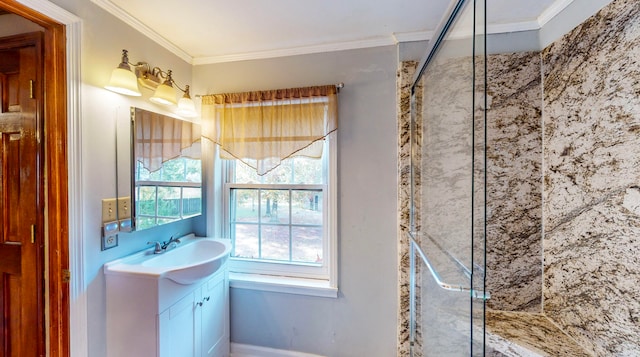 bathroom with a tile shower, vanity, and ornamental molding