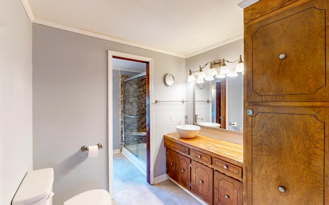 bathroom with vanity, tile patterned floors, toilet, ornamental molding, and a shower with shower door