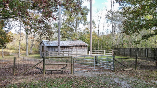 view of gate with an outbuilding