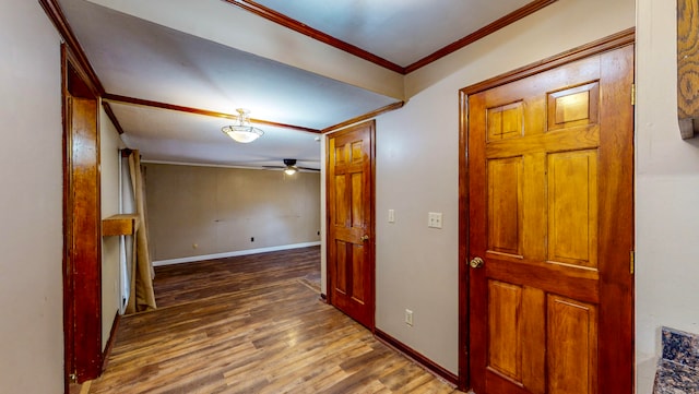 hallway with dark wood-type flooring and ornamental molding