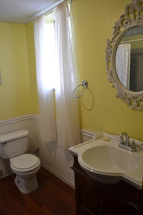 bathroom featuring hardwood / wood-style floors, vanity, and toilet