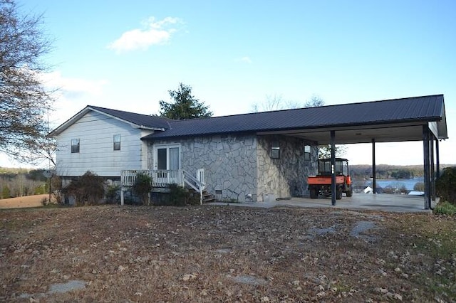 exterior space featuring a water view and a carport